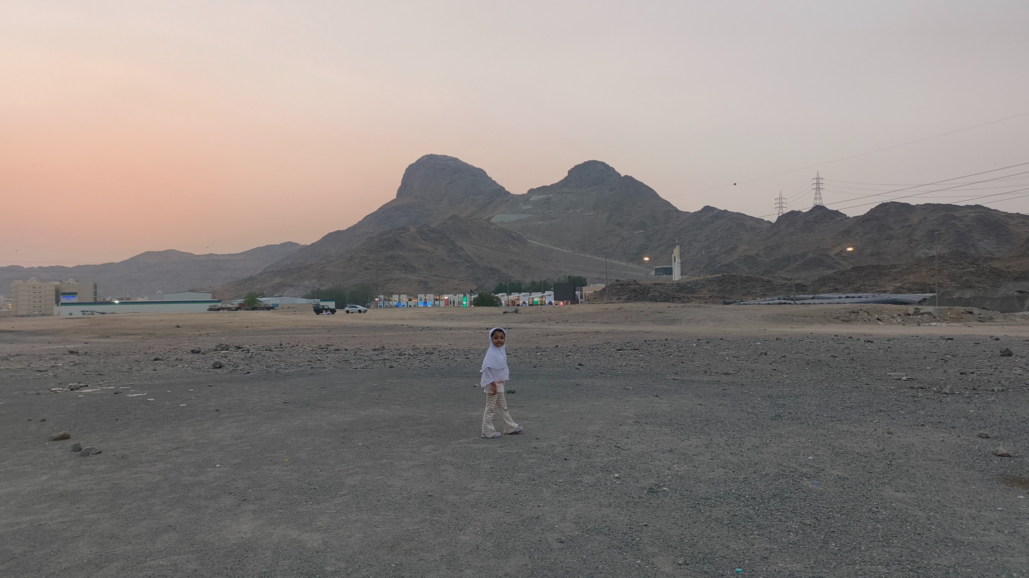 A little explorer walking through the quiet beauty of mountains at sunset.” 🌅🏔️